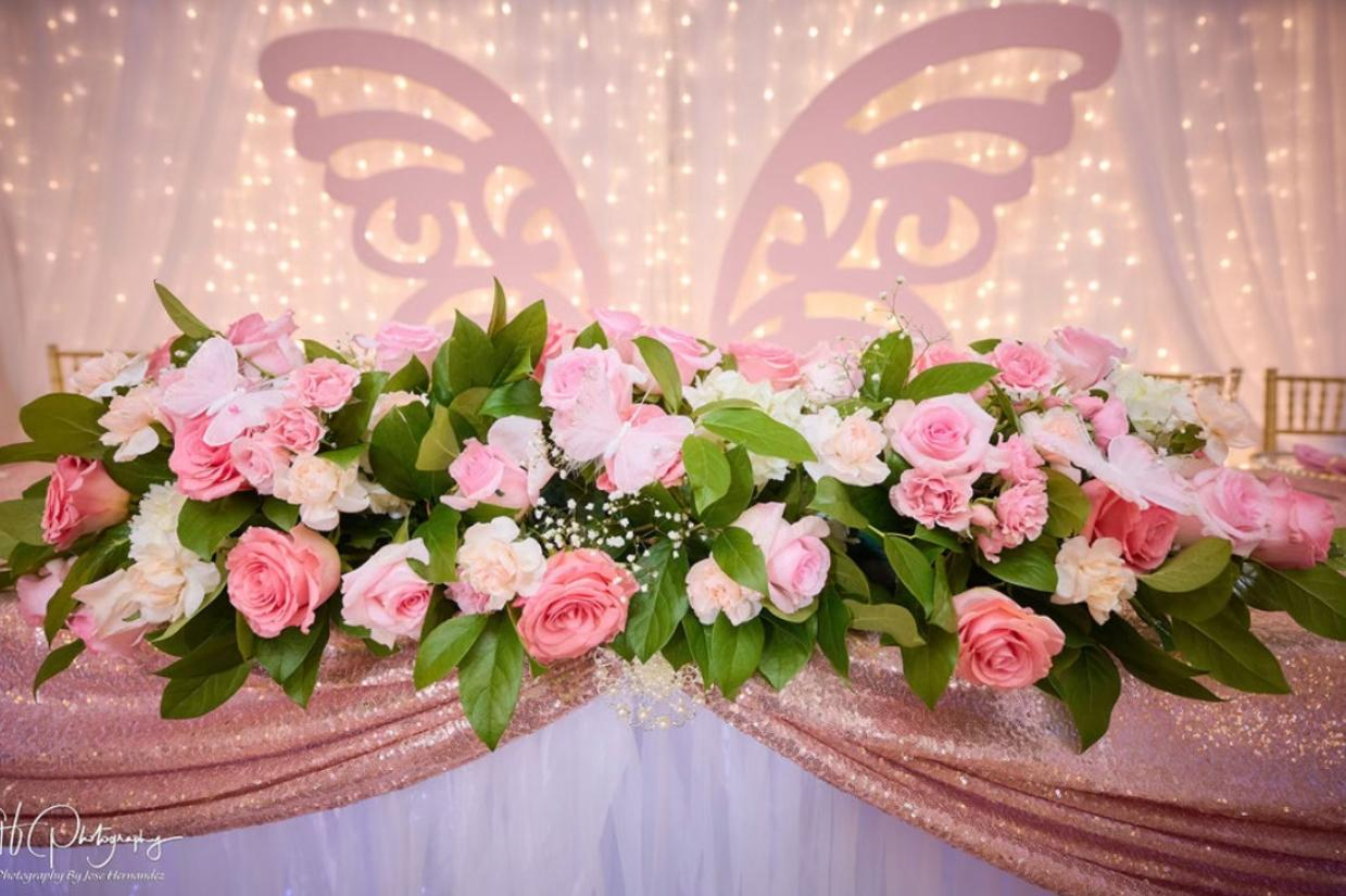 Floral centerpiece with butterfly backdrop