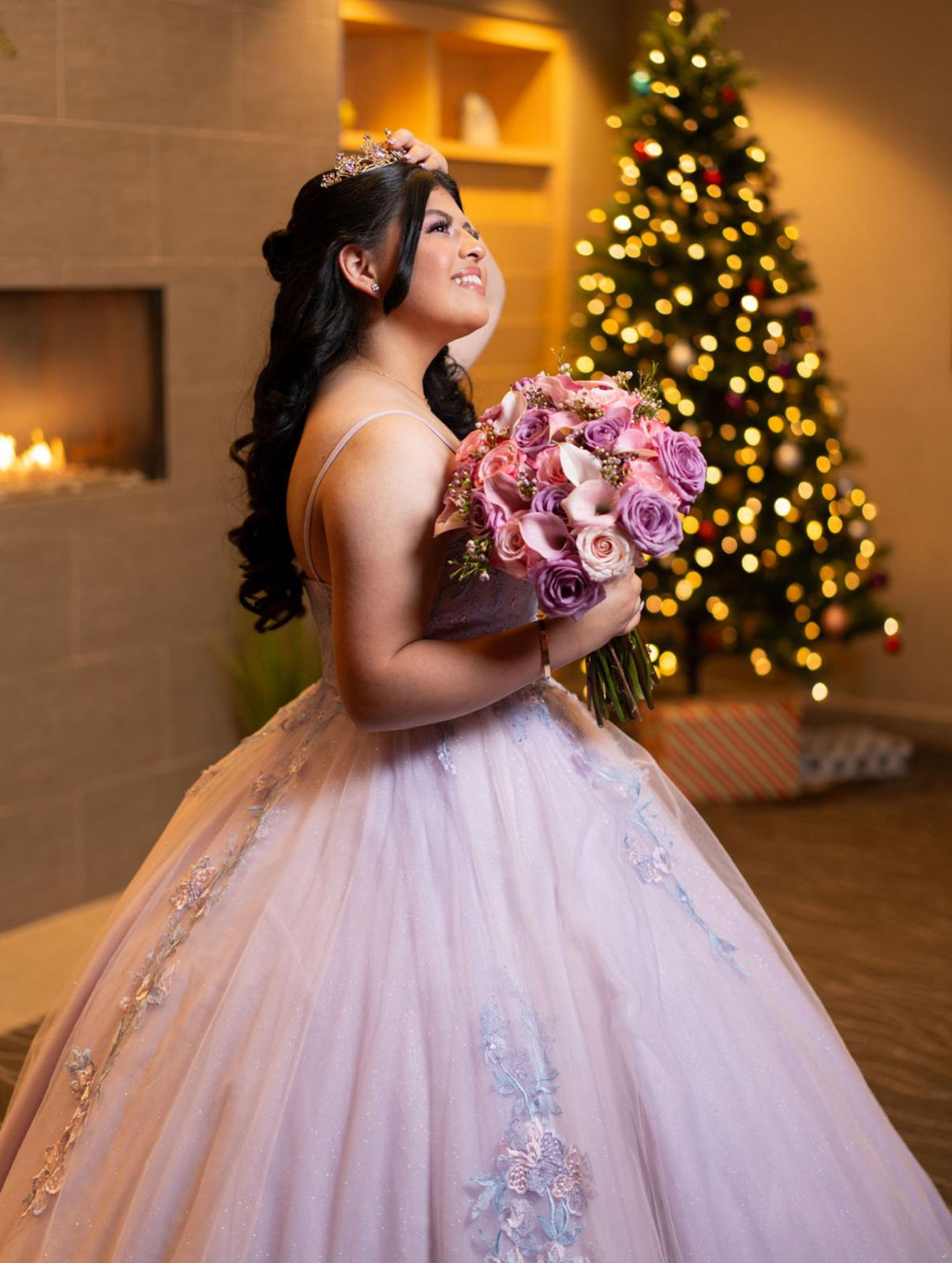 Quinceañera in blush gown holding a designed bouquet