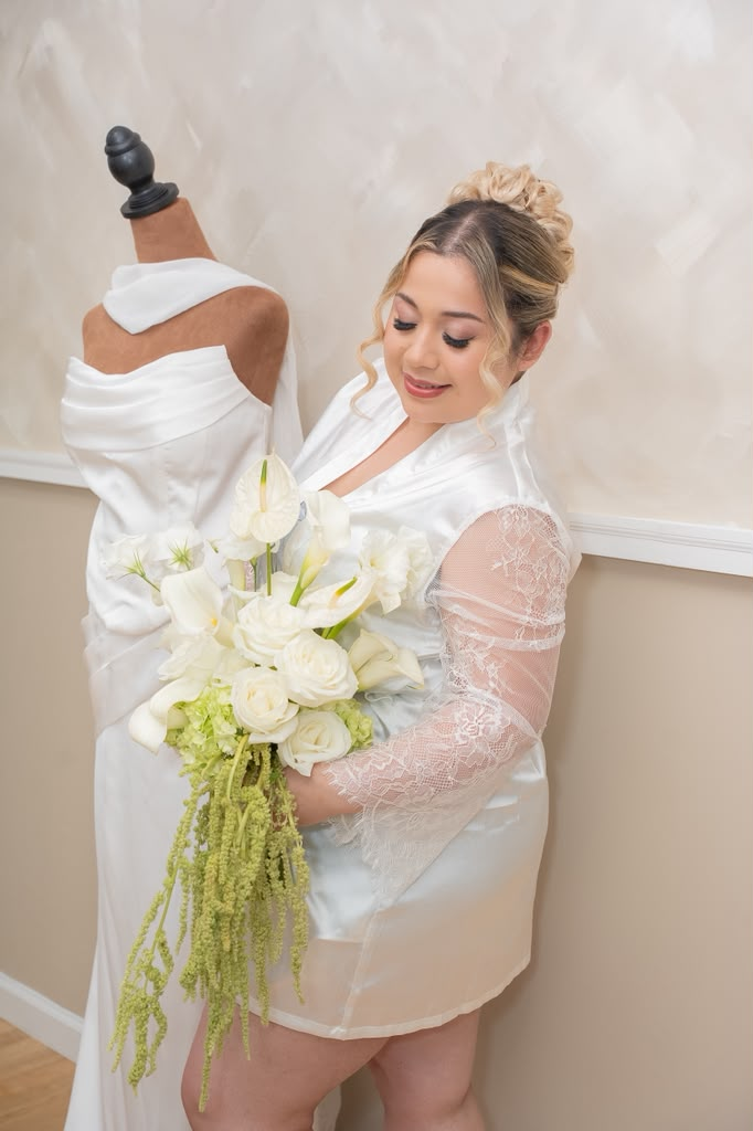 Iris Reyes holding an elegant white bridal bouquet